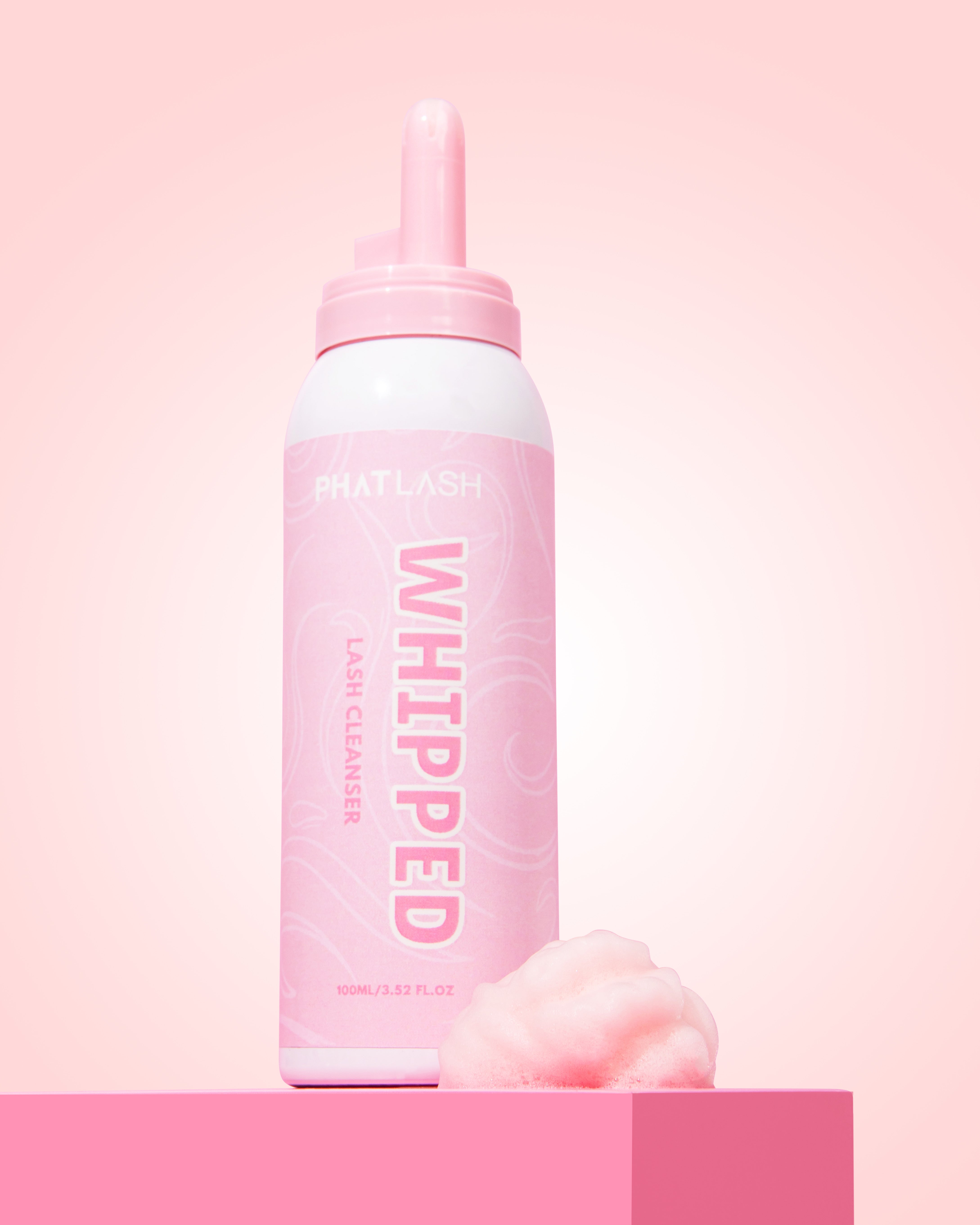 Pink bottle labeled 'Whipped' on a pink background