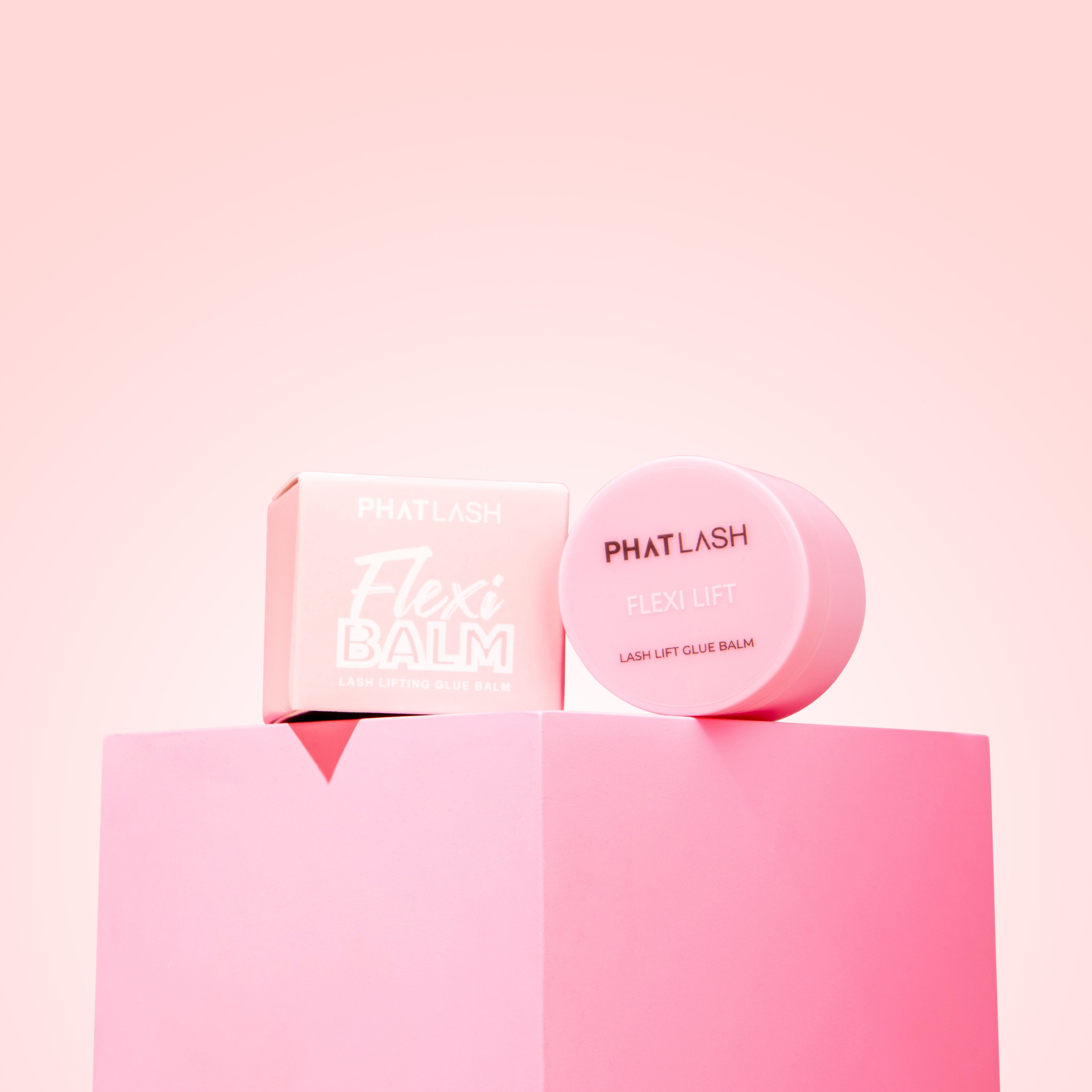 Glue Blam pot next to packaging on pink background