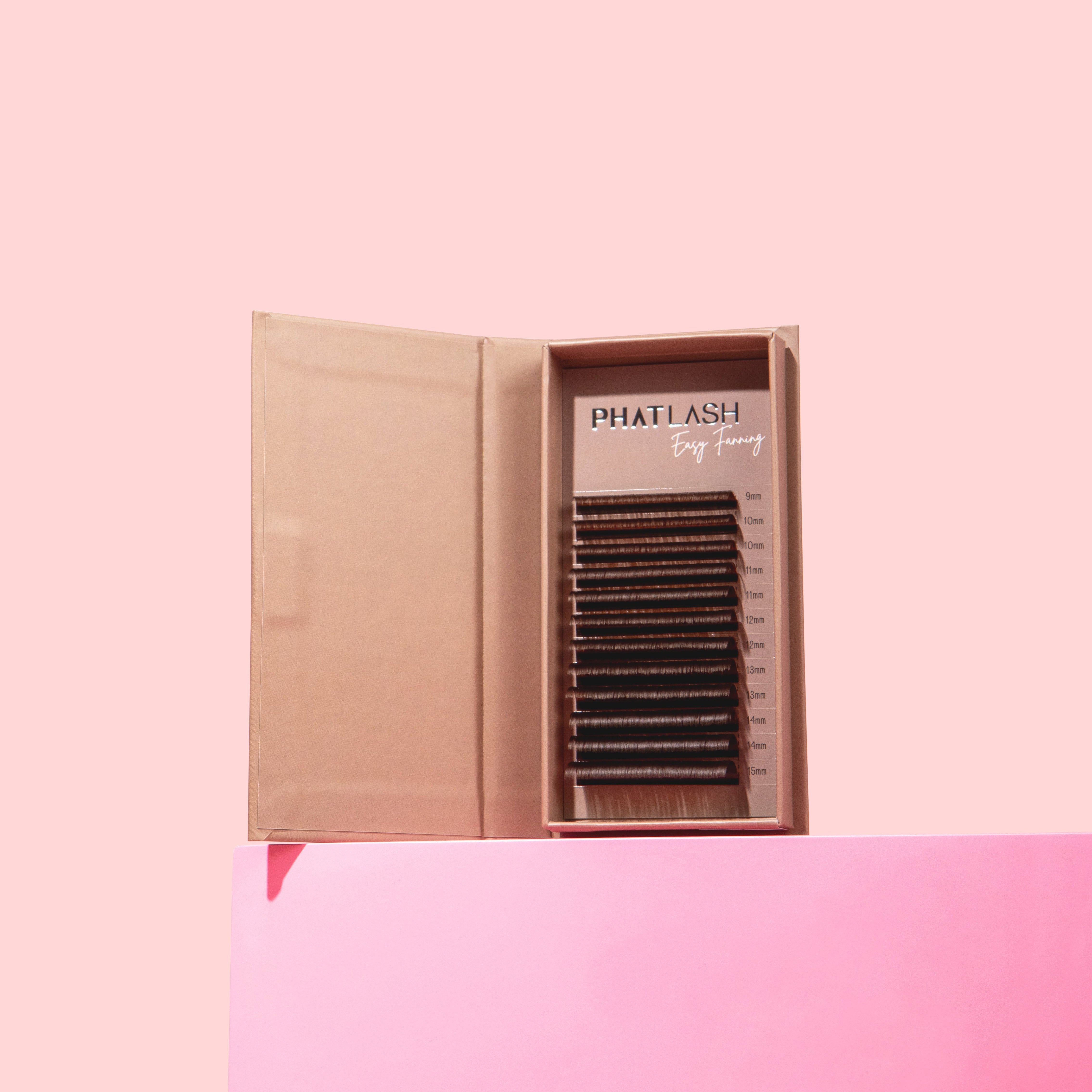 Box of false eyelashes on a pink background